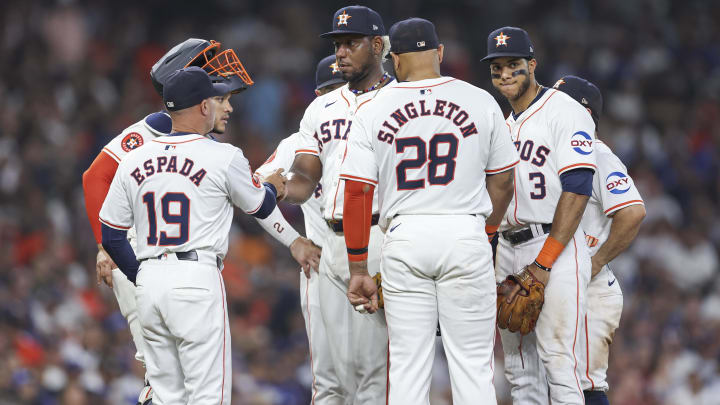 Jul 27, 2024; Houston, Texas, USA; Houston Astros starting pitcher Ronel Blanco (56) hands the ball to manager Joe Espada (19) during a pitching change in the fifth inning against the Los Angeles Dodgers at Minute Maid Park.