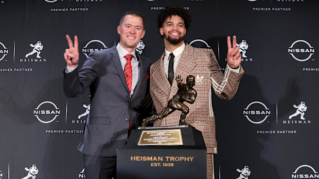 Dec 10, 2022; New York, NY, USA; Southern California quarterback Caleb Williams (right) poses for photos with coach Rile