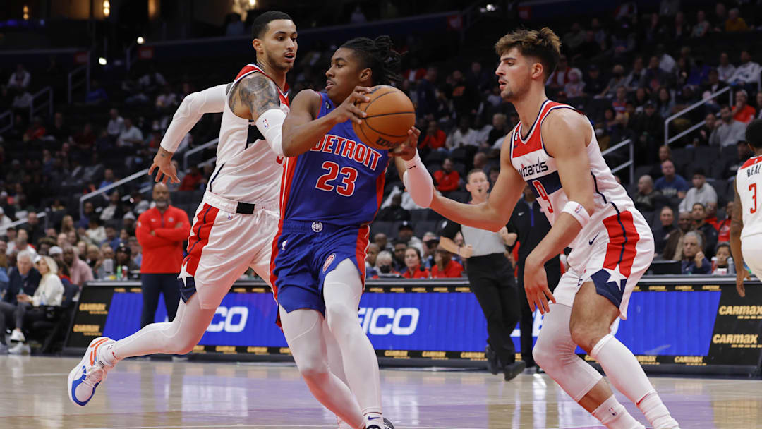 Oct 25, 2022; Washington, District of Columbia, USA; Detroit Pistons guard Jaden Ivey (23) dribbles the ball as Washington Wizards forward Deni Avdija (9) and Wizards forward Kyle Kuzma (33) defend in the second quarter at Capital One Arena. Mandatory Credit: Geoff Burke-Imagn Images