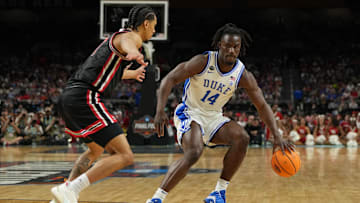 Apr 5, 2025; San Antonio, TX, USA; Duke Blue Devils guard Sion James (14) dribbles the ball against Houston Cougars guard Milos Uzan (7) during the second half in the semifinals of the men's Final Four of the 2025 NCAA Tournament at the Alamodome