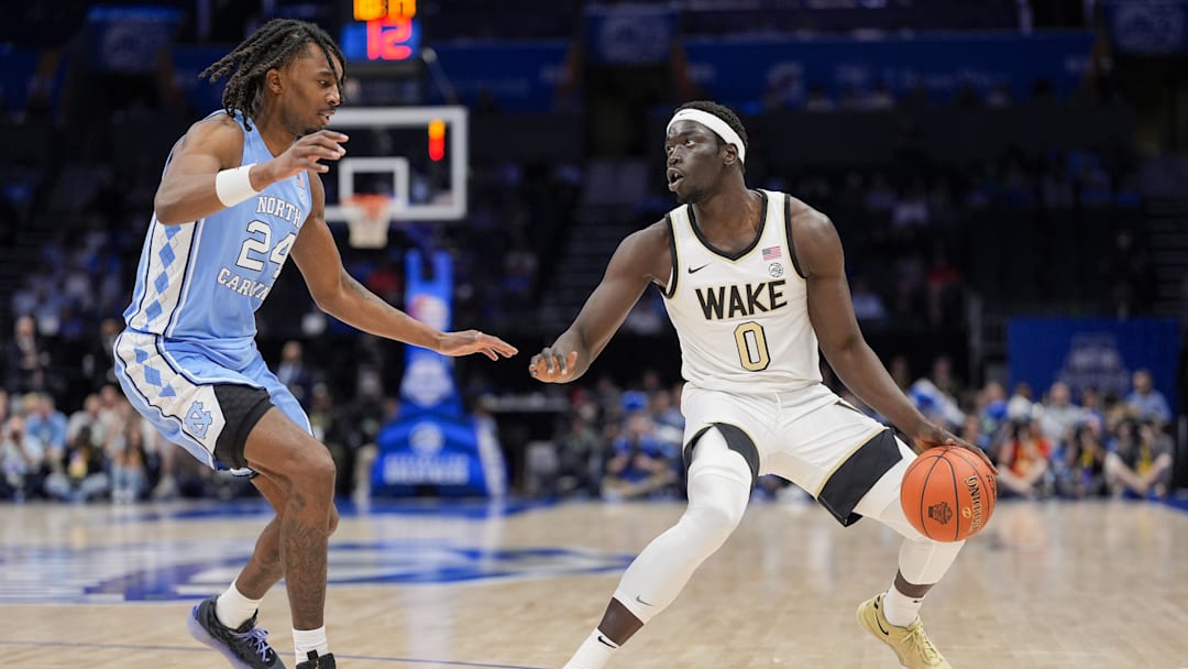 Mar 13, 2025; Charlotte, NC, USA; Wake Forest Demon Deacons forward Omaha Biliew (0) handles the ball defended by North Carolina Tar Heels forward Jae'Lyn Withers (24) during the second half at Spectrum Center. Mandatory Credit: Jim Dedmon-Imagn Images