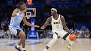 Mar 13, 2025; Charlotte, NC, USA; Wake Forest Demon Deacons forward Omaha Biliew (0) handles the ball defended by North Carolina Tar Heels forward Jae'Lyn Withers (24) during the second half at Spectrum Center. Mandatory Credit: Jim Dedmon-Imagn Images