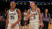 Dec 7, 2024; Brooklyn, New York, USA; Connecticut Huskies guard Azzi Fudd (35) and Connecticut Huskies guard Paige Bueckers (5) celebrate after the game against the Louisville Cardinals at Barclays Center. Mandatory Credit: Lucas Boland-Imagn Images
