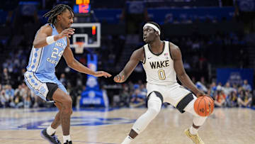 Mar 13, 2025; Charlotte, NC, USA; Wake Forest Demon Deacons forward Omaha Biliew (0) handles the ball defended by North Carolina Tar Heels forward Jae'Lyn Withers (24) during the second half at Spectrum Center. Mandatory Credit: Jim Dedmon-Imagn Images