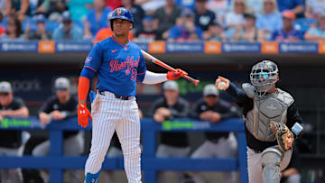 Mar 24, 2025; Port St. Lucie, Florida, USA; New York Mets right fielder Juan Soto (22) looks on toward third base as New York Yankees catcher J.C. Escarra (79) checks for a swing during the first inning at Clover Park. 