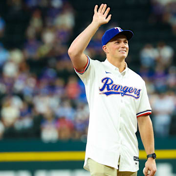 Jul 24, 2024; Arlington, Texas, USA; Texas Rangers first round draft pick Malcolm Moore throws out the first pitch before the game against the Chicago White Sox at Globe Life Field. Mandatory Credit: Kevin Jairaj-Imagn Images