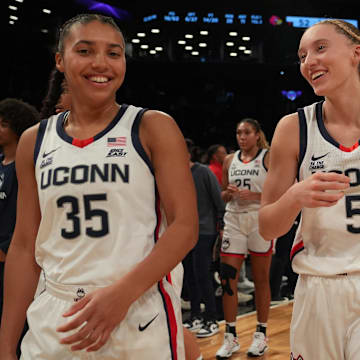 Dec 7, 2024; Brooklyn, New York, USA; Connecticut Huskies guard Azzi Fudd (35) and Connecticut Huskies guard Paige Bueckers (5) celebrate after the game against the Louisville Cardinals at Barclays Center.