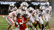 Aug 31, 2024; Tucson, Arizona, USA; Arizona Wildcats defensive back Owen Goss (27), Arizona Wildcats linebacker Taye Brown (6), Arizona Wildcats defensive back (13) and Arizona Wildcats defensive lineman Cyrus Durham (99) all tackle New Mexico Lobos tight end Trace Bruckler (5) on final play at the end of the fourth quarter at Arizona Stadium. 