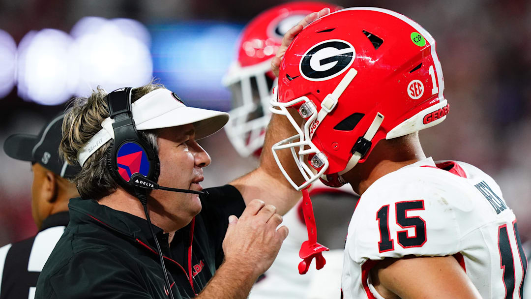 Sep 28, 2024; Tuscaloosa, Alabama, USA;  Georgia Bulldogs head coach Kirby Smart talks with quarterback Carson Beck (15) during the first half against the Alabama Crimson Tide at Bryant-Denny Stadium. Mandatory Credit: John David Mercer-Imagn Images