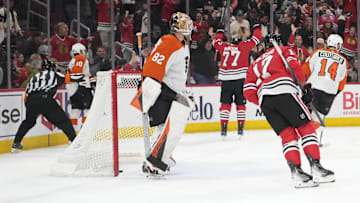 Mar 23, 2025; Chicago, Illinois, USA; Philadelphia Flyers goaltender Ivan Fedotov (82) looks on as Chicago Blackhawks left wing Patrick Maroon (77) celebrates after scoring a goal during the first period at United Center.