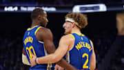 Oct 30, 2024; San Francisco, California, USA; Golden State Warriors forward Jonathan Kuminga (00) huddles with guard Brandin Podziemski (2) during the game against New Orleans Pelicans during the fourth quarter at Chase Center. Mandatory Credit: David Gonzales-Imagn Images