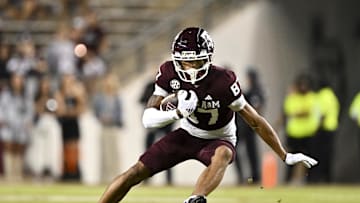 Nov 16, 2024; College Station, Texas, USA; Texas A&M Aggies wide receiver Ashton Bethel-Roman (87) runs the ball during the second half against the New Mexico State Aggies at Kyle Field. Mandatory Credit: Maria Lysaker-Imagn Images 