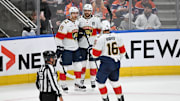 Florida Panthers center Sam Reinhart celebrates a goal with defenseman Gustav Forsling and center Aleksander Barkov.