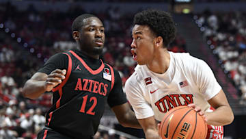sMar 5, 2024; Las Vegas, Nevada, USA; San Diego State Aztecs guard Darrion Trammell (12) defends against UNLV Rebels guard Dedan Thomas Jr. (11) in the first half at Thomas & Mack Center. Mandatory Credit: Candice Ward-Imagn Images