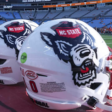 Sep 7, 2024; Charlotte, North Carolina, USA; North Carolina State Wolfpack helmets during pregame activity for the Dukes Mayo Classic against the Tennessee Volunteers at Bank of America Stadium. Mandatory Credit: Jim Dedmon-Imagn Images