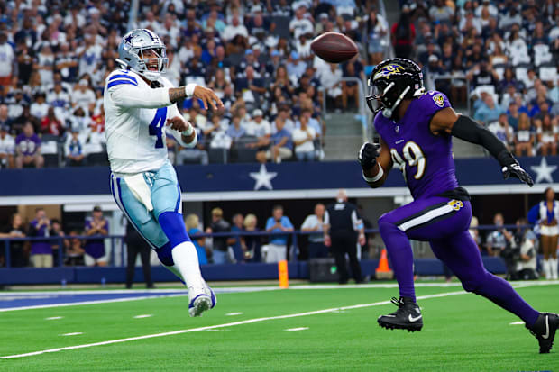 Cowboys QB Dak Prescott throws past Baltimore Ravens linebacker Odafe Oweh.