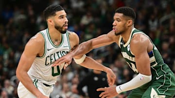 Nov 10, 2024; Milwaukee, Wisconsin, USA; Boston Celtics forward Jayson Tatum (0) and Milwaukee Bucks forward Giannis Antetokounmpo (34) jostle for position in the fourth quarter at Fiserv Forum. Mandatory Credit: Benny Sieu-Imagn Images