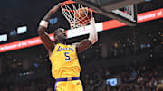 Dec 4, 2025; Toronto, Ontario, CAN; Los Angeles Lakers center Deandre Ayton (5) dunks for a basket over Toronto Raptors guard Immanuel Quickley (5) in the first half at Scotiabank Arena. Mandatory Credit: Dan Hamilton-Imagn Images