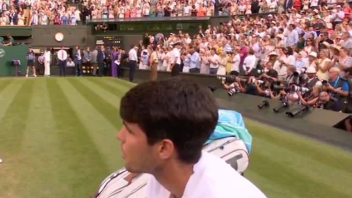 Carlos Alcaraz clapped for Jannik Sinner and looked on as he celebrated with his coaches and family. 