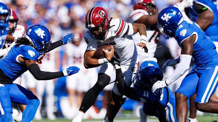 Sep 7, 2024; Lexington, Kentucky, USA; South Carolina Gamecocks quarterback Robby Ashford (1) carries the ball through Kentucky Wildcats defenders during the second quarter at Kroger Field. Mandatory Credit: Jordan Prather-Imagn Images