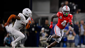 Jan 10, 2025; Arlington, TX, USA; Ohio State Buckeyes wide receiver Jeremiah Smith (4) and Texas Longhorns defensive back Jahdae Barron (7) in action during the game between the Texas Longhorns and the Ohio State Buckeyes at AT&T Stadium. Mandatory Credit: Jerome Miron-Imagn Images
