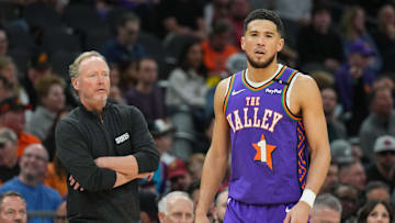Jan 11, 2025; Phoenix, Arizona, USA; Phoenix Suns head coach Mike Budenholzer looks on alongside Phoenix Suns guard Devin Booker (1) against the Utah Jazz during the first half at Footprint Center. Mandatory Credit: Joe Camporeale-Imagn Images