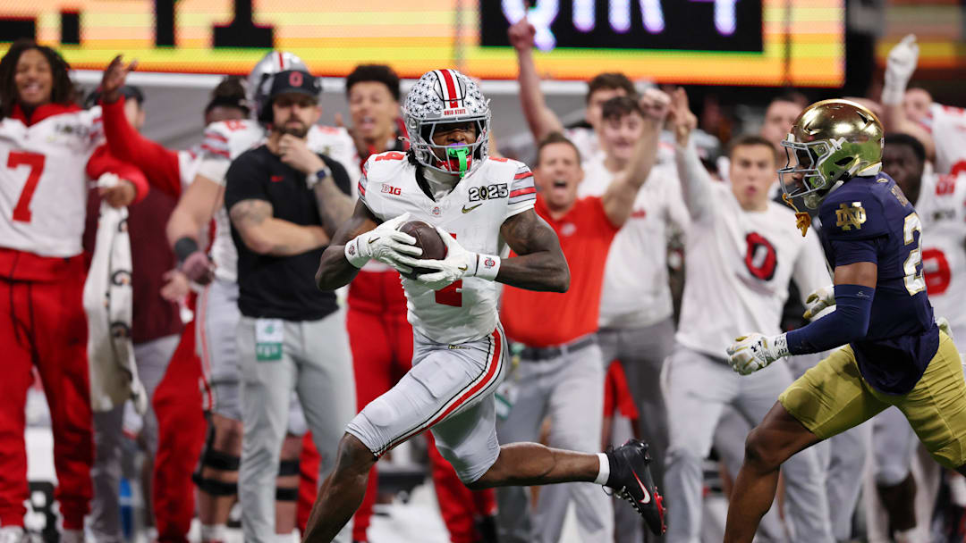 Jan 20, 2025; Atlanta, GA, USA; Ohio State Buckeyes wide receiver Jeremiah Smith (4) makes a catch against the Notre Dame Fighting Irish during the second half the CFP National Championship college football game at Mercedes-Benz Stadium. Mandatory Credit: Brett Davis-Imagn Images