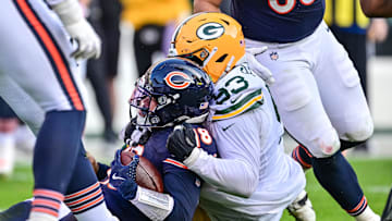Chicago Bears quarterback Caleb Williams (18) is sacked by Green Bay Packers defensive tackle TJ Slaton.