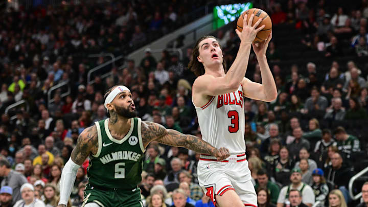 Nov 20, 2024; Milwaukee, Wisconsin, USA;  Chicago Bulls guard Josh Giddey (3) shoots against Milwaukee Bucks guard Gary Trent Jr. (5) in the first quarter at Fiserv Forum. Mandatory Credit: Benny Sieu-Imagn Images