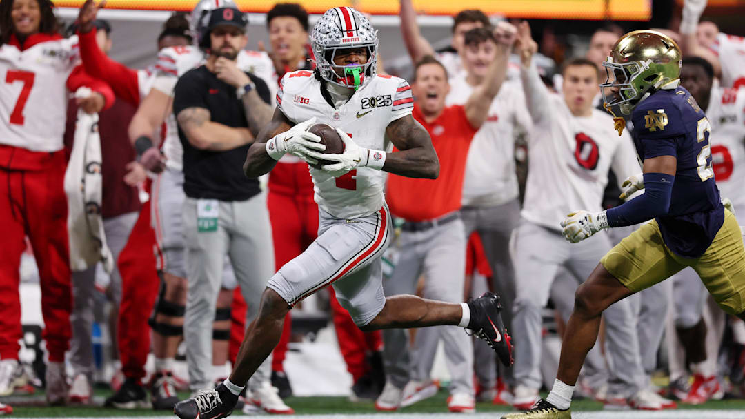 Jan 20, 2025; Atlanta, GA, USA; Ohio State Buckeyes wide receiver Jeremiah Smith (4) makes a catch against the Notre Dame Fighting Irish during the second half of the CFP National Championship college football game at Mercedes-Benz Stadium. Mandatory Credit: Brett Davis-Imagn Images