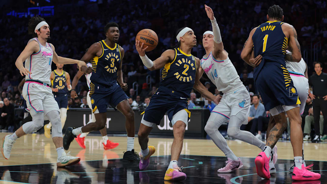 Feb 28, 2025; Miami, Florida, USA; Indiana Pacers guard Andrew Nembhard (2) drives to the basket against Miami Heat guard Tyler Herro (14) during the second quarter at Kaseya Center. Mandatory Credit: Sam Navarro-Imagn Images