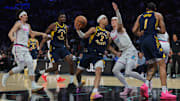 Feb 28, 2025; Miami, Florida, USA; Indiana Pacers guard Andrew Nembhard (2) drives to the basket against Miami Heat guard Tyler Herro (14) during the second quarter at Kaseya Center. Mandatory Credit: Sam Navarro-Imagn Images