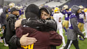 Interim Husky head coach Bob Gregory hugs an Arizona State coach following their game in 2021 in Montlake. 