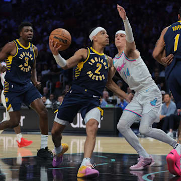 Feb 28, 2025; Miami, Florida, USA; Indiana Pacers guard Andrew Nembhard (2) drives to the basket against Miami Heat guard Tyler Herro (14) during the second quarter at Kaseya Center. Mandatory Credit: Sam Navarro-Imagn Images