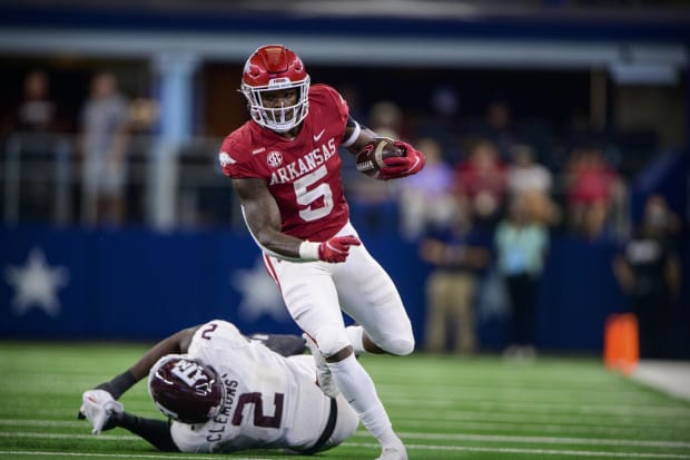 Arkansas Razorbacks running back Raheim Sanders (5) breaks a tackle by Texas A&M Aggies defensive lineman Micheal Clemons (2)