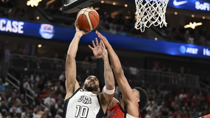 Jul 10, 2024; Las Vegas, Nevada, USA; USA forward Jayson Tatum (10) shoots against Canada guard Jamal Murray (4) in the second quarter in the USA Basketball Showcase at T-Mobile Arena.