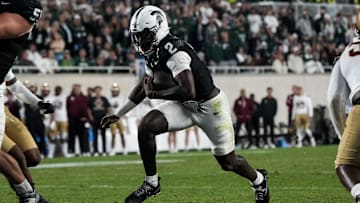 Sep 6, 2025; East Lansing, Michigan, USA; Michigan State quarterback Aidan Chiles (2) runs the ball into the end zone in double-overtime at Spartan Stadium. Mandatory Credit: Brendan Mullin-Imagn Images