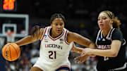 Mar 22, 2025; Storrs, Connecticut, USA; UConn Huskies forward Sarah Strong (21) drives the ball against Arkansas State Red Wolves guard Wynter Rogers (2) in the first half at Harry A. Gampel Pavilion. Mandatory Credit: David Butler II-Imagn Images