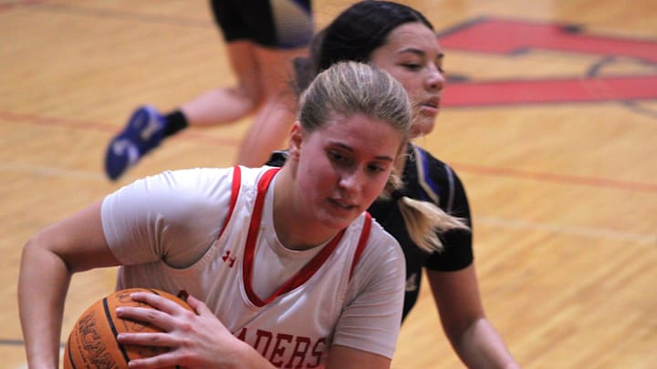 Bishop Kenny guard Kathleen Crawley (22) pulls down a rebound in front of Menendez guard Princess Watkins (3) during the FHSAA District 4-4A high school girls basketball final on Feb. 6, 2025. [Clayton Freeman/Florida Times-Union]