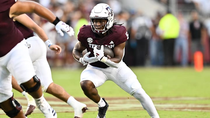 Aug 31, 2024; College Station, Texas, USA; Texas A&M Aggies running back Amari Daniels (5) runs the ball during the first quarter against the Notre Dame Fighting Irish at Kyle Field.