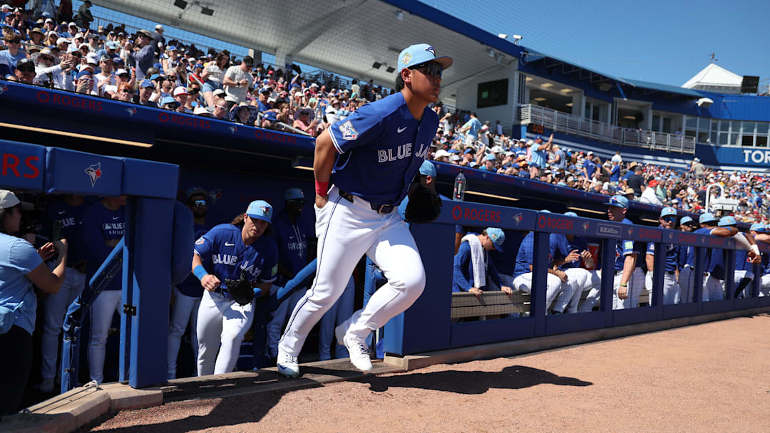 Feb 21, 2026; Dunedin, Florida, USA; Toronto Blue Jays third baseman Kazuma Okamoto (7) runs out onto the field  for the start of spring training games against the Philadelphia Phillies at TD Ballpark. Mandatory Credit: Kim Klement Neitzel-Imagn Images
