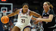Mar 22, 2025; Storrs, Connecticut, USA; UConn Huskies forward Sarah Strong (21) drives the ball against Arkansas State Red Wolves guard Wynter Rogers (2) in the first half at Harry A. Gampel Pavilion. Mandatory Credit: David Butler II-Imagn Images