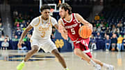 Mar 5, 2025; South Bend, Indiana, USA; Stanford Cardinal guard Benny Gealer (5) drives to the basket as Notre Dame Fighting Irish guard Markus Burton (3) defends in the second half at the Purcell Pavilion. Mandatory Credit: Matt Cashore-Imagn Images