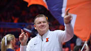 Dec 29, 2024; Champaign, Illinois, USA;  Illinois Fighting Illini head coach Brad Underwood acknowledges the fans before a game with the Chicago State Cougars at State Farm Center. Mandatory Credit: Ron Johnson-Imagn Images