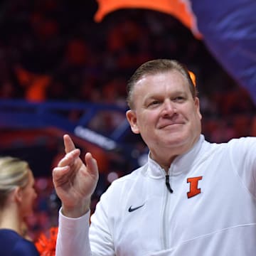 Dec 29, 2024; Champaign, Illinois, USA;  Illinois Fighting Illini head coach Brad Underwood acknowledges the fans before a game with the Chicago State Cougars at State Farm Center. Mandatory Credit: Ron Johnson-Imagn Images