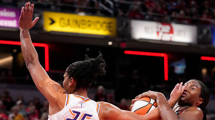 Indiana Fever forward Aliyah Boston (7) recovers the ball against Phoenix Mercury forward Alyssa Thomas (25) on Wednesday, July 30, 2025, during the game at Gainbridge Fieldhouse in Indianapolis.