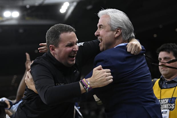 Wade celebrates with Rousse after defeating Clemson in the NCAA tournament.