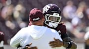 Sep 27, 2025; College Station, Texas, USA; Texas A&M Aggies head coach Mike Elko greets cornerback Will Lee III (4) prior to the game against the Auburn Tigers at Kyle Field. Mandatory Credit: Maria Lysaker-Imagn Images 