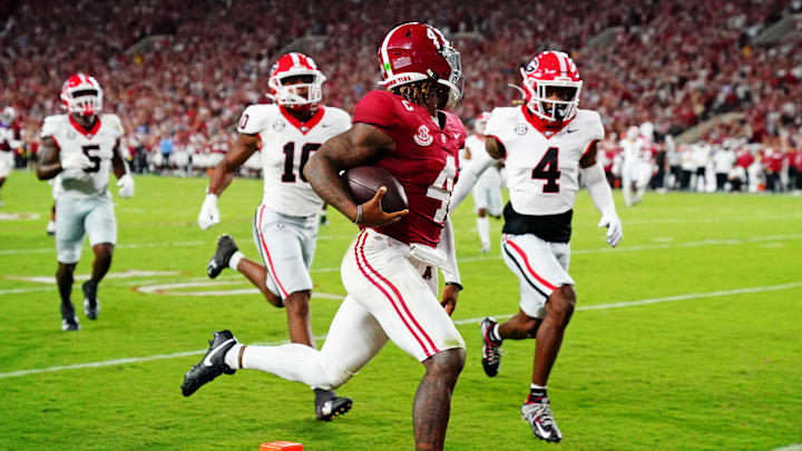 Sep 28, 2024; Tuscaloosa, Alabama, USA; Alabama Crimson Tide quarterback Jalen Milroe (4) scores a touchdown during the second quarter against the Georgia Bulldogs at Bryant-Denny Stadium. Mandatory Credit: John David Mercer-Imagn Images
