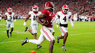 Sep 28, 2024; Tuscaloosa, Alabama, USA; Alabama Crimson Tide quarterback Jalen Milroe (4) scores a touchdown during the second quarter against the Georgia Bulldogs at Bryant-Denny Stadium. Mandatory Credit: John David Mercer-Imagn Images